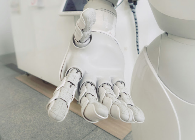 Close-up of a white humanoid robot's articulated hand.